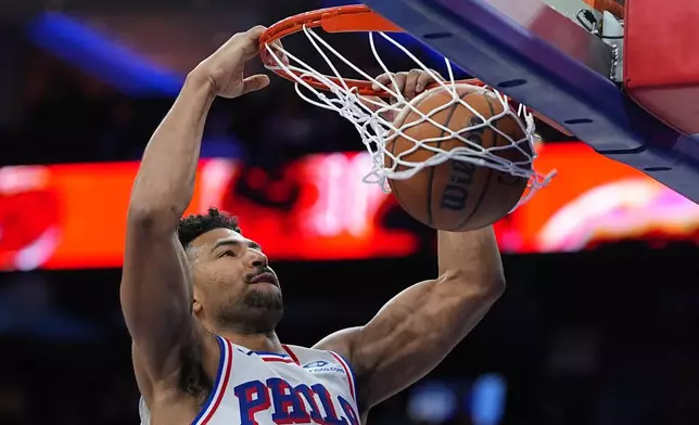 Philadelphia 76ers' Quentin Grimes dunks during the second half of an NBA basketball game against the Brooklyn Nets, Saturday, March 14, 2026, in Philadelphia. (AP Photo/Matt Rourke)