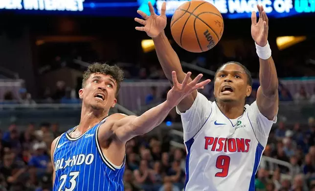 Orlando Magic forward Tristan da Silva (23) and Detroit Pistons guard Ausar Thompson (9) go after a rebound during the first half of an NBA basketball game, Sunday, March 1, 2026, in Orlando, Fla. (AP Photo/John Raoux)