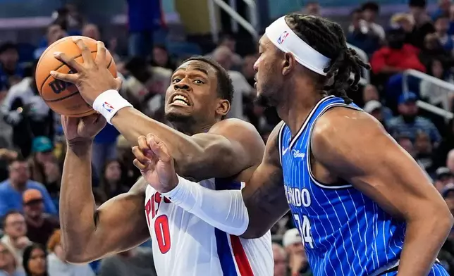 Detroit Pistons center Jalen Duren (0) goes to the basket against Orlando Magic center Wendell Carter Jr., right, during the first half of an NBA basketball game, Sunday, March 1, 2026, in Orlando, Fla. (AP Photo/John Raoux)