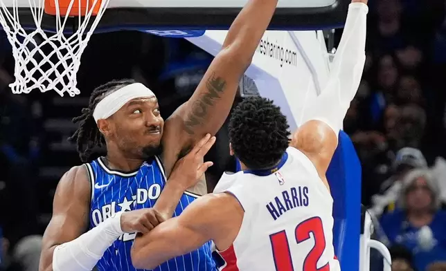 Orlando Magic center Wendell Carter Jr., left, tries to block a shot by Detroit Pistons forward Tobias Harris (12) during the second half of an NBA basketball game, Sunday, March 1, 2026, in Orlando, Fla. (AP Photo/John Raoux)