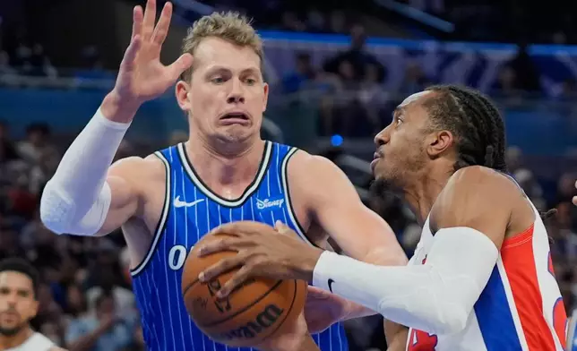 Detroit Pistons guard Daniss Jenkins, right, looks to shoot against Orlando Magic forward Moritz Wagner, left during the first half of an NBA basketball game, Sunday, March 1, 2026, in Orlando, Fla. (AP Photo/John Raoux)