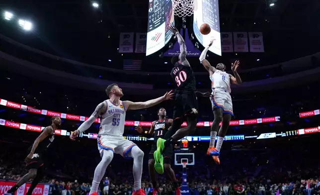 Oklahoma City Thunder's Jalen Williams (8) goes up for a shot against Philadelphia 76ers' Adem Bona (30) during the first half of an NBA basketball game Monday, March 23, 2026, in Philadelphia. (AP Photo/Matt Slocum)