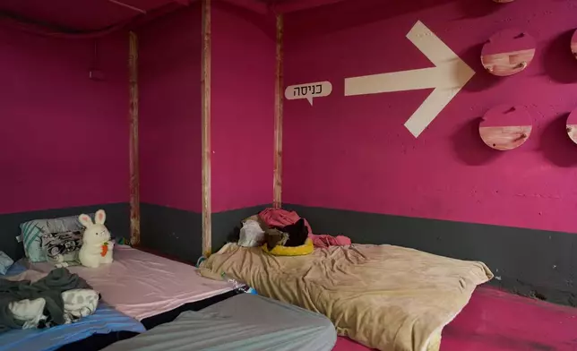 A child's stuffed rabbit sits on one of the mattresses spread across an underground parking garage where people spend the night as a precaution against possible Iranian missile attacks in Tel Aviv, Israel, Saturday, March 14, 2026. (AP Photo/Oded Balilty)