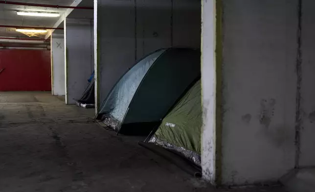 Tents are seen set up beneath Tel Aviv's central bus station, where people shelter as a precaution against possible Iranian missile attacks, Thursday, March 12, 2026. (AP Photo/Oded Balilty)