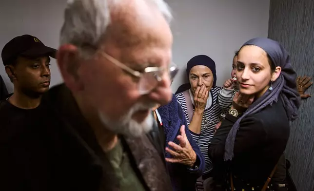 People take cover in a bomb shelter beneath a shopping mall as air raid sirens warn of incoming missiles from Iran in Ramat Gan, Israel, Tuesday, March 17, 2026. (AP Photo/Oded Balilty)