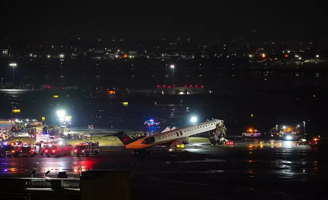 An Air Canada Jet sits on the runway at LaGuardia Airport, Monday, March 23, 2026, after colliding with a Port Authority aircraft rescue and firefighting vehicle in New York. (AP Photo/Ryan Murphy)