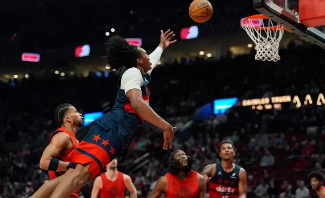 Washington Wizards guard Bub Carrington dives while going to the basket during the first half of an NBA basketball game against the Portland Trail Blazers, Sunday, March 29, 2026, in Portland, Ore. (AP Photo/Jenny Kane)
