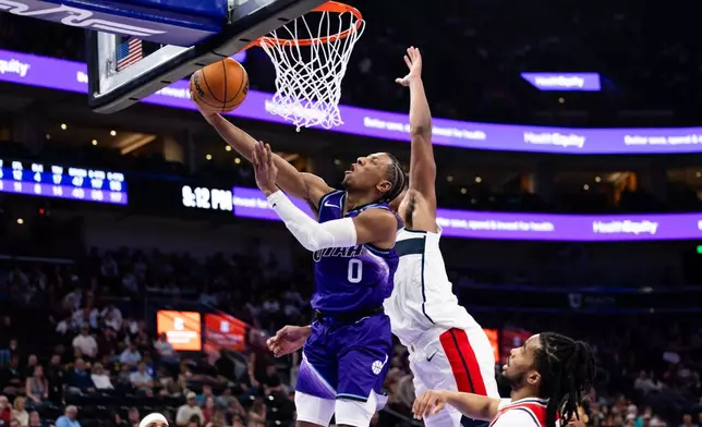 Utah Jazz forward Kennedy Chandler (0) shoots a layup during the second half of an NBA basketball game against the Washington Wizards, Wednesday, March 25, 2026, in Salt Lake City. (AP Photo/Anna Fuder)