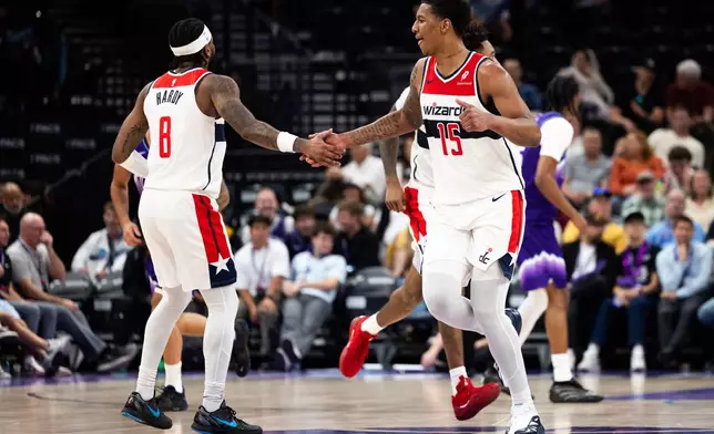 Washington Wizards forward Juju Reese (15) and Washington Wizards guard Jaden Hardy (8) high five during the second half of an NBA basketball game against the Utah Jazz, Wednesday, March 25, 2026, in Salt Lake City. (AP Photo/Anna Fuder)