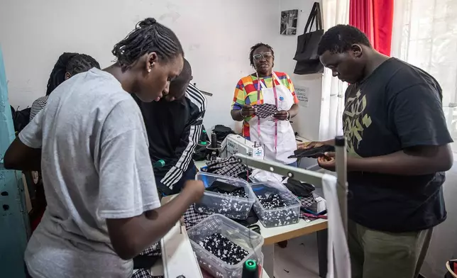 Volunteers sew reusable sanitary pads inside the Fempad NGO workshop in the Kibera informal settlement on the outskirts of Nairobi, Kenya, Feb. 12, 2026. (AP Photo/Atieno Muyuyi)