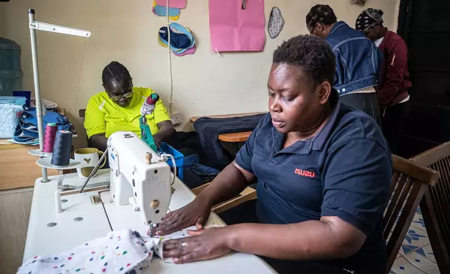 Women sew reusable sanitary pads inside the Fempad NGO workshop in the Kibera informal settlement on the outskirts of Nairobi, Kenya, Feb. 12, 2026. (AP Photo/Atieno Muyuyi)