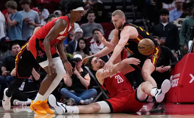 Houston Rockets center Alperen Sengun (28) passes against Atlanta Hawks center Jock Landale (31) during the first half of an NBA basketball game in Houston, Friday, March 20, 2026. (AP Photo/Ashley Landis)