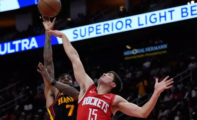 Atlanta Hawks guard Nickeil Alexander-Walker (7) shoots against Houston Rockets guard Reed Sheppard (15) during the first half of an NBA basketball game in Houston, Friday, March 20, 2026. (AP Photo/Ashley Landis)