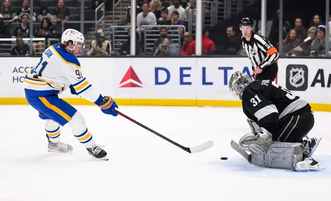 Los Angeles Kings goaltender Anton Forsberg (31) blocks a shot by Buffalo Sabres right wing Josh Doan during the first period of an NHL hockey game Saturday, March 21, 2026, in Los Angeles. (AP Photo/William Liang)