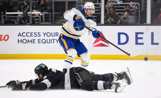 Buffalo Sabres defenseman Bowen Byram (4) shoots the puck past Los Angeles Kings defenseman Joel Edmundson (6) during the first period of an NHL hockey game Saturday, March 21, 2026, in Los Angeles. (AP Photo/William Liang)
