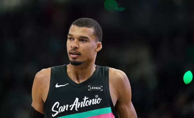 San Antonio Spurs' Victor Wembanyama looks on during the first half of an NBA basketball game against the Milwaukee Bucks, Saturday, March 28, 2026, in Milwaukee. (AP Photo/Aaron Gash)