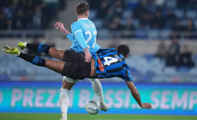 Lazio's Daniel Maldini, and Atalanta's Isak Hien, behind, fight for the ball during the Frecciarossa Italian Cup soccer match between Lazio and Atalanta in, Rome, Italy, Wednesday March 4, 2026. (Alfredo Falcone/LaPresse via AP)