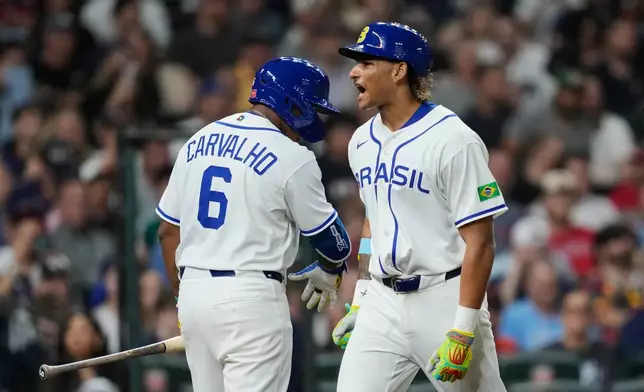Brazil's Lucas Ramirez, right, celebrates with Osvaldo Carvalho after hitting a solo home run during the first inning of a World Baseball Classic game against the United States, Friday, March 6, 2026, in Houston. (AP Photo/Ashley Landis)