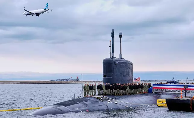 Sailors stand at attention on the USS Massachusetts during a rehearsal ahead of the commissioning of the Navy's newest nuclear-powered attack submarine, Friday, March 27, 2026, in Boston. (AP Photo/Robert F. Bukaty)