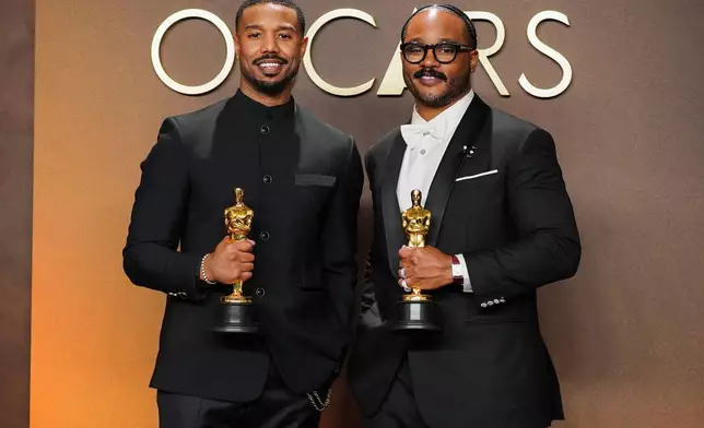 Michael B. Jordan, left, winner of the award for actor in a leading role for "Sinners," and Ryan Coogler, winner of the award for writing (original screenplay) for "Sinners," pose in the press room at the Oscars on Sunday, March 15, 2026, at the Dolby Theatre in Los Angeles. (Photo by Jordan Strauss/Invision/AP)