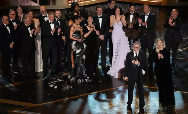 Anthony Carlino, from left, Alana Haim, Will Weiske, Florencia Martin, Andy Jurgensen, Shayna McHale, Reginal Hall, Teyana Taylor, Cassandra Kulukundis, Leonardo DiCaprio, Benicio del Toro, Chase Infiniti, Tony Villaflor, Christopher Scarabosio, Jose Antonio Garcia, Paul Thomas Anderson, and Sara Murphy accept the award for best picture for "One Battle After Another" during the Oscars on Sunday, March 15, 2026, at the Dolby Theatre in Los Angeles. (AP Photo/Chris Pizzello)