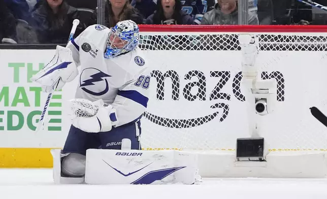 Tampa Bay Lightning goaltender Andrei Vasilevskiy (88) makes a save against the Seattle Kraken during the second period of an NHL hockey game Tuesday, March 17, 2026, in Seattle. (AP Photo/Lindsey Wasson)