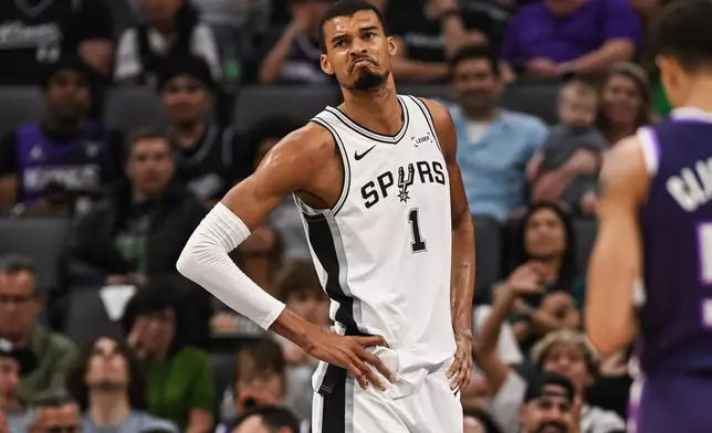 San Antonio Spurs forward Victor Wembanyama (1) reacts during the first half of an NBA basketball game against the Sacramento Kings, Tuesday, March 17, 2026, in Sacramento, Calif. (AP Photo/Justine Willard)