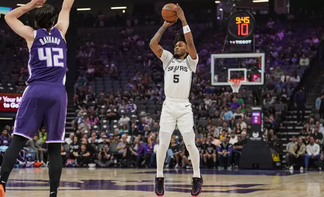 San Antonio Spurs guard Stephon Castle (5) shoots a 3-point basket during the first half of an NBA basketball game against the Sacramento Kings, Tuesday, March 17, 2026, in Sacramento, Calif. (AP Photo/Justine Willard)