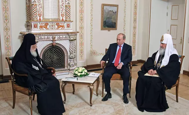 FILE - Russian President Vladimir Putin, center, meets with Georgian Orthodox Patriarch Ilia II, left, and Russian Orthodox Patriarch Kirill at the Novo-Ogaryovo residence outside Moscow, Wednesday, Jan. 23, 2013. (Mikhail Klimentyev/Sputnik, Kremlin Pool Photo via AP, File)
