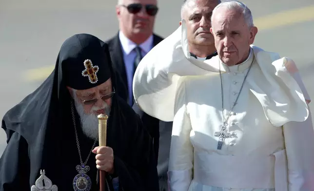 FILE - Pope Francis and Georgian Orthodox Patriarch Ilia II, left, attend a welcoming ceremony shortly upon his landing in Tbilisi, Georgia, on Friday, Sept. 30, 2016. (AP Photo/Ivan Sekretarev, File)