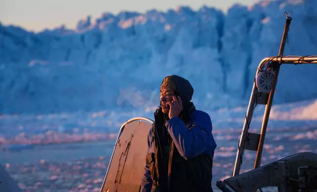 A fisherman rides on a boat at Disko Bay near Ilulissat, Greenland, on Wednesday, Jan. 28, 2026. (AP Photo/Evgeniy Maloletka)
