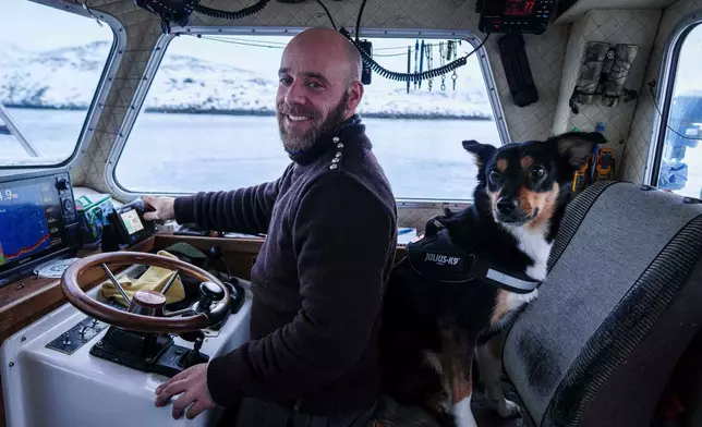 Helgi Aargil, fisherman, with his dog Molly, sails on his boat near Nuuk, Greenland, on Wednesday, Jan. 21, 2026. (AP Photo/Evgeniy Maloletka)