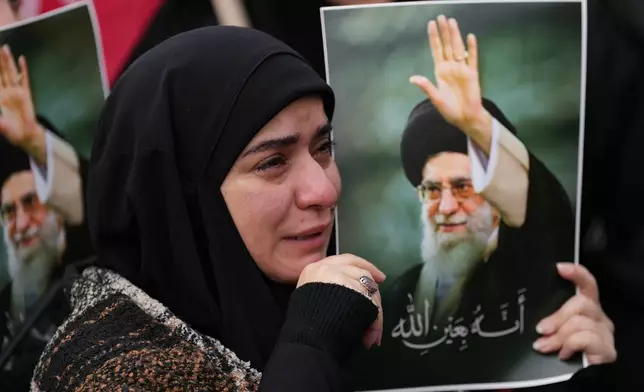 A woman cries as she mourns the death of Iranian Supreme Leader Ayatollah Ali Khamenei, during a gathering in the southern Suburb of Beirut, Lebanon, Sunday, March 1, 2026. (AP Photo/Hassan Ammar)