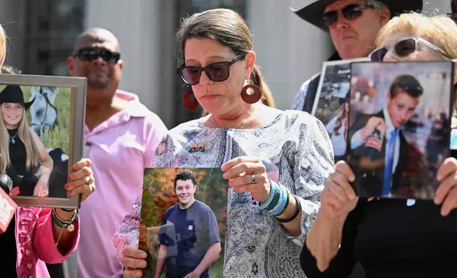 Mary Rodee holds a photo of her son Riley after the verdict in a landmark trial over whether social media platforms deliberately addict and harm children at Los Angeles Superior Court, Wednesday, March 25, 2026, in Los Angeles. (AP Photo/William Liang)