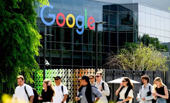 People walk through Google headquarters in Mountain View, Calif., on Thursday, March 26, 2026. (AP Photo/Noah Berger)