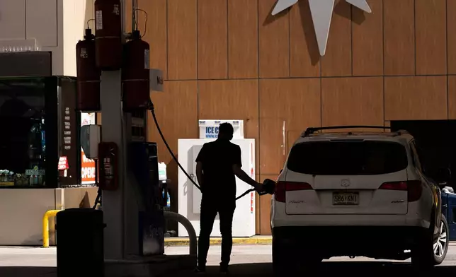 FILE - A person fuels up a vehicle at a gas station, Tuesday, March 10, 2026, in New York. (AP Photo/Yuki Iwamura, File)