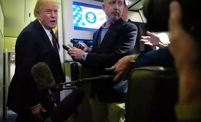 President Donald Trump speaks to reporters aboard Air Force One, Sunday, March 15, 2026, en route from West Palm Beach, Fla. to Joint Base Andrews, Md. (AP Photo/Mark Schiefelbein)