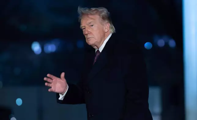 President Donald Trump gesture to the media as he walks on the South Lawn upon his arrival to the White House, Sunday, March 15, 2026, in Washington. (AP Photo/Jose Luis Magana)