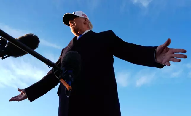 President Donald Trump speaks to reporters before he boards Air Force One, Friday, March 13, 2026, at Joint Base Andrews, Md., for a trip to Florida. (AP Photo/Mark Schiefelbein)