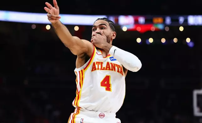Atlanta Hawks guard Gabe Vincent reacts after a 3-pointer during the first half of an NBA basketball game against the Brooklyn Nets, Thursday, March 12, 2026, in Atlanta. (AP Photo/Colin Hubbard)