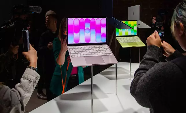 Members of the media view MacBook Neo laptop computers on display during an Apple unveil event, Wednesday, March 4, 2026, in New York (AP Photo/Ted Shaffrey) ,