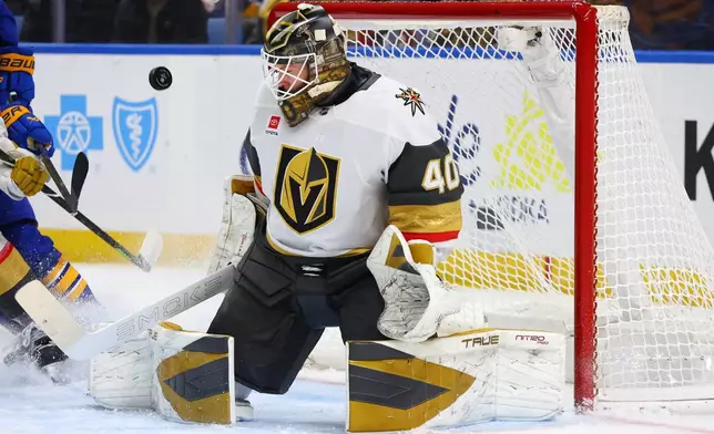 Vegas Golden Knights goaltender Akira Schmid (40) makes a pad save during the first period of an NHL hockey game against the Buffalo Sabres, Tuesday, March 3, 2026, in Buffalo, N.Y. (AP Photo/Jeffrey T. Barnes)