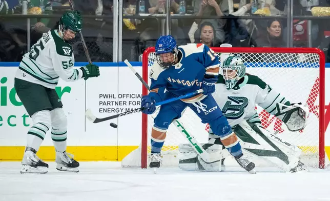 Boston Fleet goaltender Aerin Frankel (31) stops Vancouver Goldeneyes' Mannon McMahon (19) as Boston's Daniela Pejsova (55) watches during the second period of a PWHL game in Vancouver, on Tuesday, March 10, 2026. (Ethan Cairns/The Canadian Press via AP)