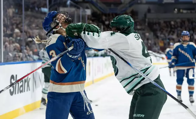 Vancouver Goldeneyes' Tereza Vanisova (13) is pushed by Boston Fleet's Jill Saulnier (44) during the first period of a PWHL game in Vancouver, on Tuesday, March 10, 2026. (Ethan Cairns/The Canadian Press via AP)