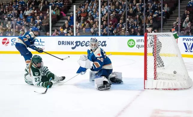 Boston Fleet's Shay Maloney (27) scores on Vancouver Goldeneyes goaltender Kristen Campbell (50) as Sarah Nurse (20) watches during overtime of a PWHL hockey game in Vancouver, on Tuesday, March 10, 2026. (Ethan Cairns/The Canadian Press via AP)