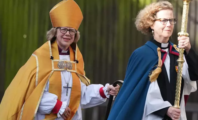 Sarah Mullally, left, arrives for the Enthronement Ceremony installing her as archbishop of Canterbury in Canterbury, England, Wednesday, March 25, 2026, the first woman ever to lead the Church of England. (AP Photo/Alastair Grant)