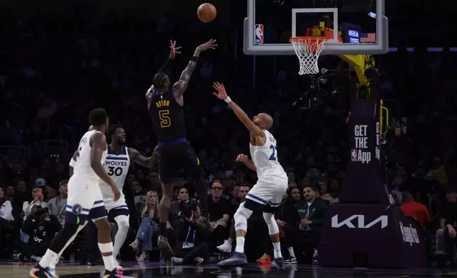 Los Angeles Lakers center Deandre Ayton (5) shoots against the Minnesota Timberwolves during the first half of an NBA basketball game, Tuesday, March 10, 2026, in Los Angeles. (AP Photo/Ethan Swope)