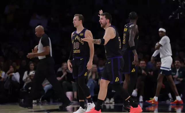 Los Angeles Lakers guard Luka Doncic (77) reacts during the first half of an NBA basketball game against the Minnesota Timberwolves, Tuesday, March 10, 2026, in Los Angeles. (AP Photo/Ethan Swope)