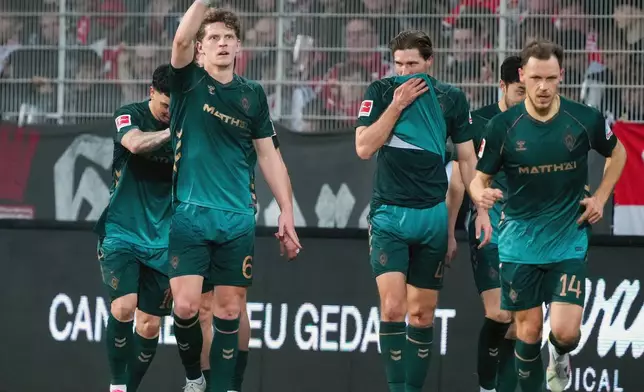 Werder's Jens Stage, 2nd left, celebrates scoring their side's second goal during the German Bundesliga soccer game between Union Berlin and Werder Bremen in Berlin, Germany, Sunday, March 8, 2026. (Soeren Stache/dpa via AP)