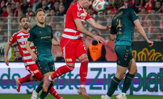 Union Berlin's Andrej Ilic and Bremen's Niklas Stark, right, in action during the German Bundesliga soccer game between Union Berlin and Werder Bremen in Berlin, Germany, Sunday, March 8, 2026. (Soeren Stache/dpa via AP)